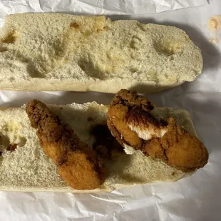 two pieces of chicken on a bun