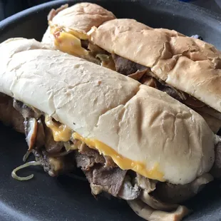 My two ribeye steaks (philly cheese steaks!) reheating when I got them home, plenty of meat chz and extras!