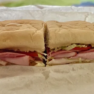 Super Sub with Turkey, Ham, Salami, Provolone cheese, lettuce, tomato.  16 inches, cut into fourths.