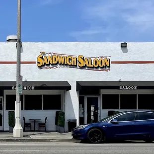 a blue car parked in front of it