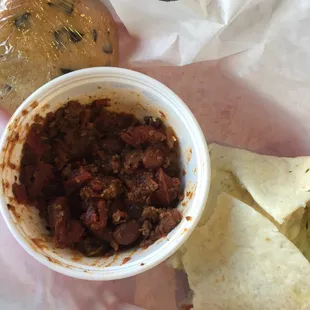a bowl of chili and tortilla