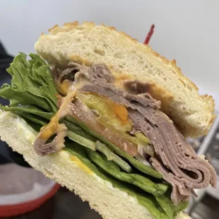 a roast beef sandwich with lettuce
