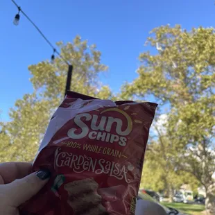 Artsy photo of sun chip and tree in outside seating
