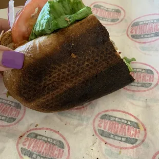 a sandwich with lettuce, tomato, and lettuce