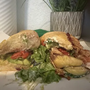 a sandwich cut in half with lettuce and tomato