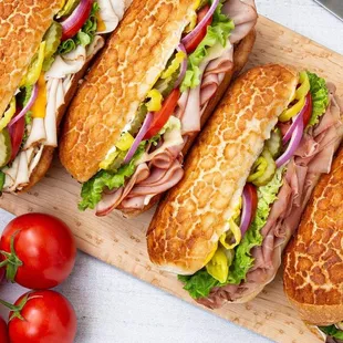 four sandwiches on a cutting board