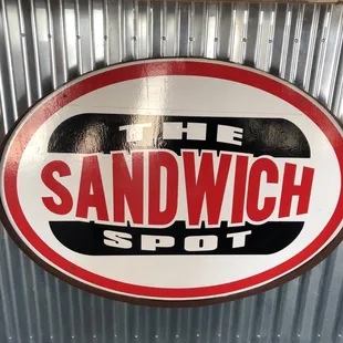 a sign for the sandwich spot