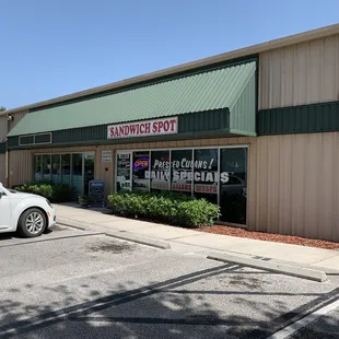 a car parked in front of the sandwich spot