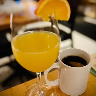 a glass of orange juice and a cup of coffee