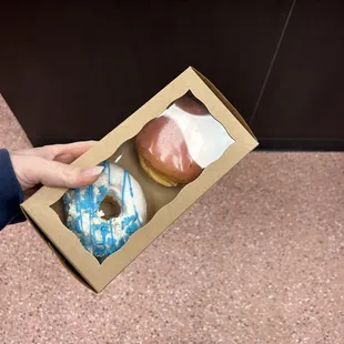 The strawberry donut with white frosting filling &amp; a yeast donut with vanilla frosting