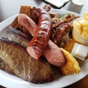 The "Legit Food Baby" meat platter with side of mac n cheese and corn muffin