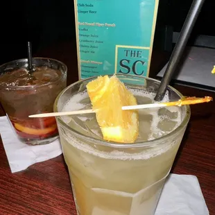 a cocktail with a pineapple garnish