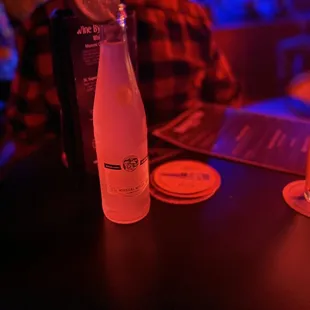 a bottle of water and coasters