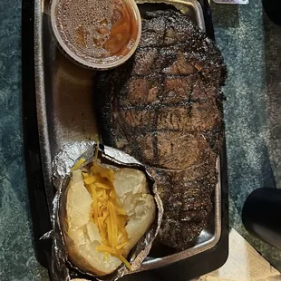 Ribeye, baked potato and baked beans.