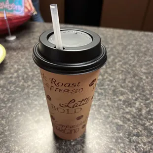 a coffee cup with a straw