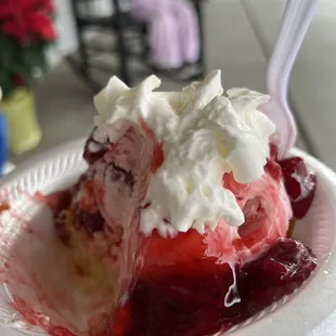 Strawberry shortcake with a warm slice of home made pound cake at the bottom.