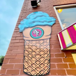 an ice cream cone painted on the side of a building