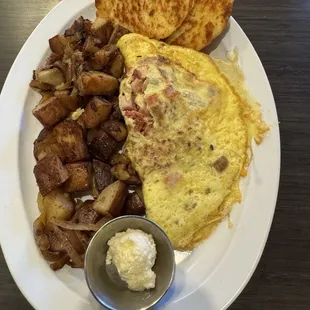 Meat lovers omelette with home fries and grilled biscuit