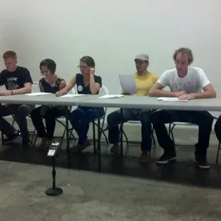 The actors reading the sketch manuscript