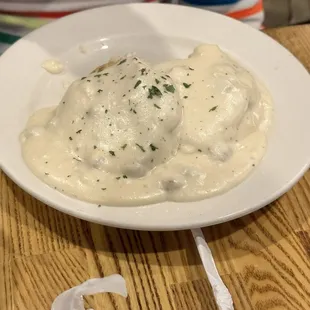 Biscuit with gravy. Eggs on side .