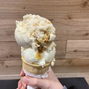 a person holding an ice cream cone