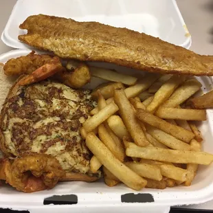 a sandwich and fries in a styrofoam container
