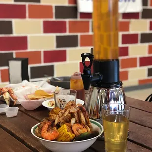 a plate of shrimp and a beer