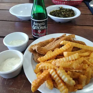3 Spicy Basa Fish, thick cut seasoned fries, and Sangria (non-alcoholic grape beverage). Brother John's greens can be seen in the bowl.