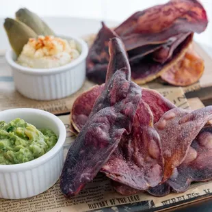 a plate of food with chips and guacamole