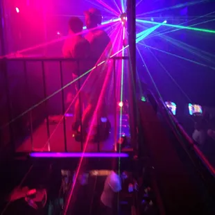 a man standing on a platform in front of a laser light