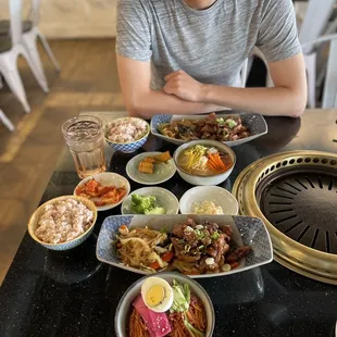 a man sitting at a table full of food