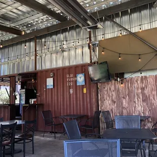 tables, chairs, and a flat screen tv