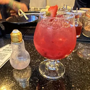 a cocktail with a strawberry garnish