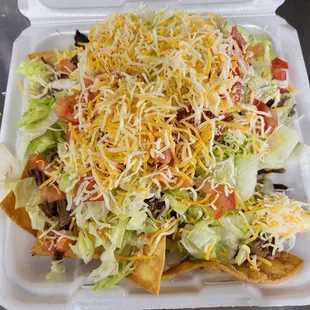 a salad in a styrofoam container
