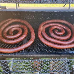 two hot dogs on a grill