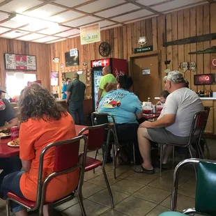 people sitting at tables in a restaurant