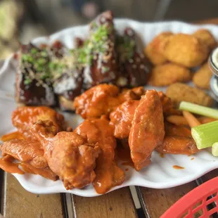 a plate of buffalo wings and celery