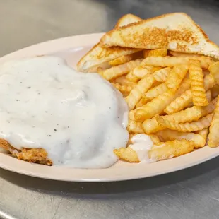 a plate of food with fries and gravy