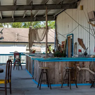 a bar with a blue counter and yellow stools