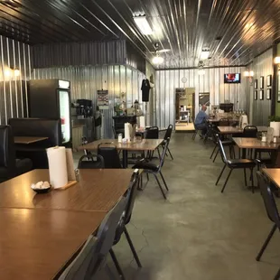 the inside of a restaurant with tables and chairs