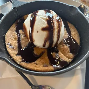Cookie skillet with vanilla ice cream and chocolate syrup on top