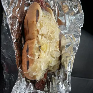a hot dog with sauerkraut and sauerkraut