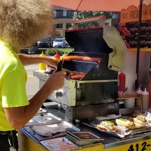 John grilling and serving the yummy dogs.