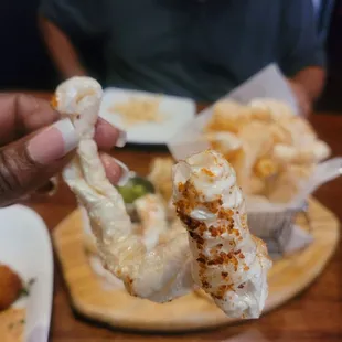 a hand holding a piece of food