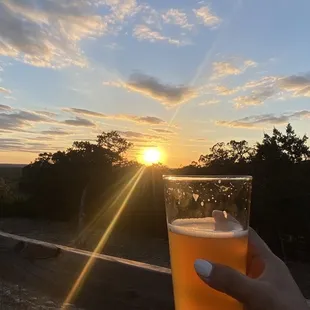 a person holding a glass of beer