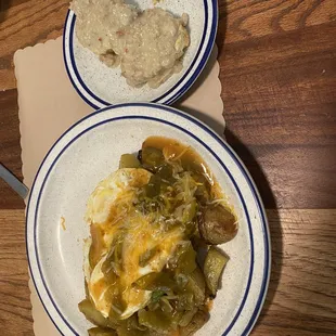 Baked avocado topped with green chili and jalepeno biscuits and homemade meat gravy