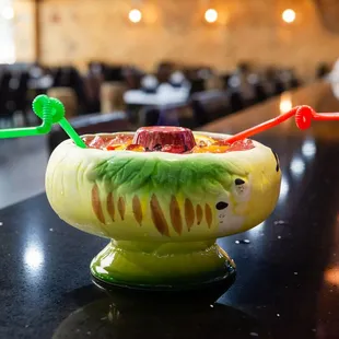 a drink in a bowl with strawberries and raspberries