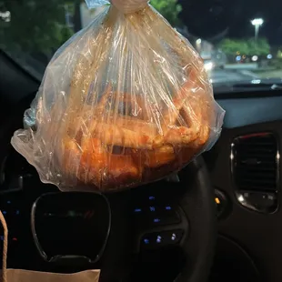 a person holding a bag of food