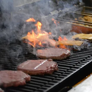 burgers cooking on a grill