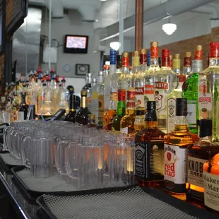 a row of liquor bottles on a bar